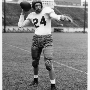 North Carolina State College tailback Roland Eveland from Pittsburgh, Pennsylvania, posing with football at Riddick Stadium.
