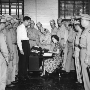 Frank Verlinden and Betty Hamrick of the Institute of Statistics demonstrate the use of the Electric Key Punch to Quartermaster Corps ROTC cadets.