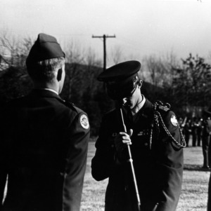Officer inspecting a cadet's artillery