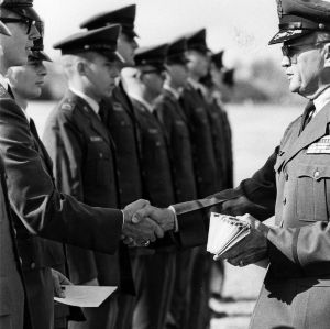 Officer distributing letters to cadets