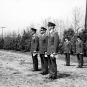 Officers and cadets stand at attention