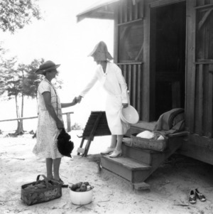 Cornelia Simpson, Home Demonstration agent for Craven County, meeting with another women at Camp Kiro