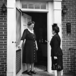 Miss Douglas Hand greeting Eleanor Mason in doorway