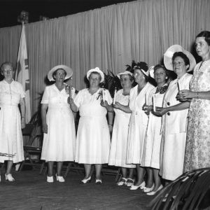 Group of women singing on stage