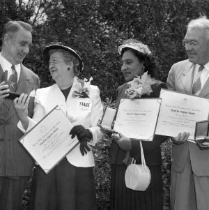 Senator Willis Smith and home extension workers with certificates