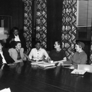 Home Demonstration members sitting at conference table, North Carolina State College