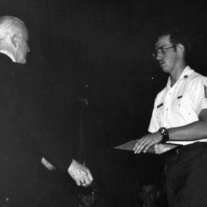 Officer presenting a cadet with an award