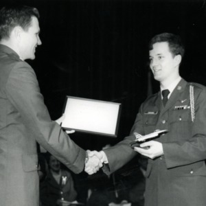 Officer presenting a cadet with an award