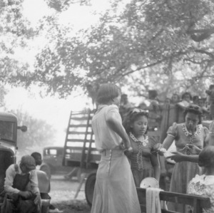 African American 4-H Club girls selling ice cream at picnic for funds to send delegates to Short Course, 1941