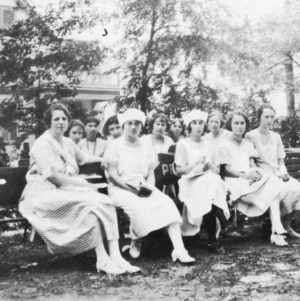Group of Extension Club members sitting on benches