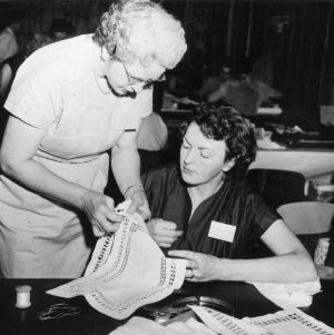Two women working together on a sewing project