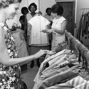Group of women looking through racks of clothing
