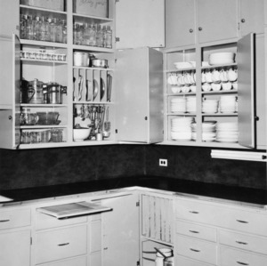 Interior view of a kitchen with cabinet doors open