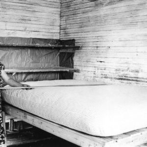 Woman flattening homemade mattress