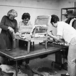 Susan Atkinson, Hazel Longest, and Johnsie Barringer refurbishing a chair