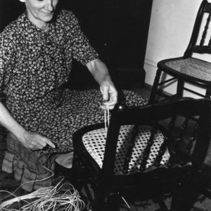Mrs. W. D. McNairy of Greensboro, North Carolina, recaning chairs