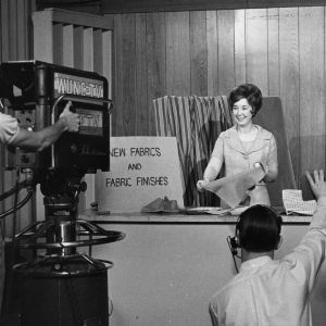 Home economics extension worker showing new fabrics and fabric finishes on camera in WUNC-TV studio, May 24, 1967