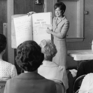Home economics extension worker showing "Project Record Books" to group of people, June 12, 1967