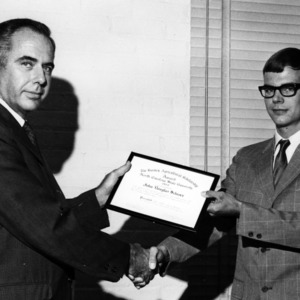 Dr. H. B. Craig presenting John Douglas Schroer with scholarship
