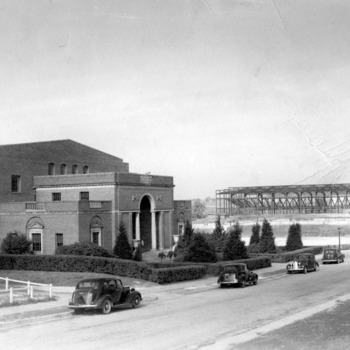 Thompson Gymnasium, with Reynolds Coliseum under construction in the background