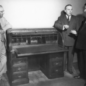 Ira O. Schaub, Chancellor J. W. Harrelson, and other with desk which the bill establishing North Carolina State College was drawn