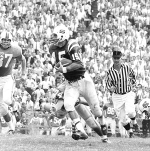 North Carolina State College quarterback Gerry Mancini running with the football against North Carolina.