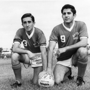 North Carolina State College's all-Southern forward Benito Artinano (3) and Harry Maheras (9) posing with soccer ball.