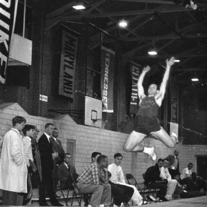 North Carolina State University long jumper Bill Banks competing at indoor meet.