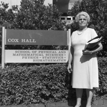Gertrude Cox standing in front of Cox Hall
