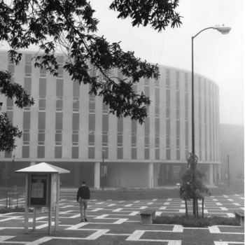 Student walking across University Plaza (the Brickyard) toward Harrelson Hall, North Carolina State University.