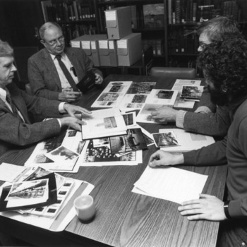 From left, Murray Downs, Burton Beers, Jim Rasor, and Jimmy Williams review photographs in the NCSU University Archives