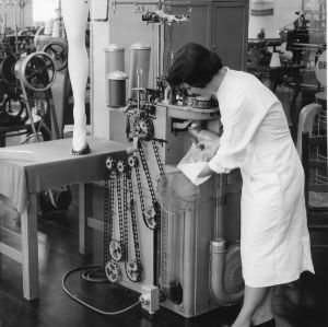 A view in the nylon hosiery knitting section showing a Fidelity 400 knitting machine. This machine was donated to the School of Textiles in 1958.
