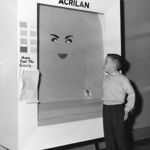 Young boy looking at an exibit for Acrilan acrylic fiber.