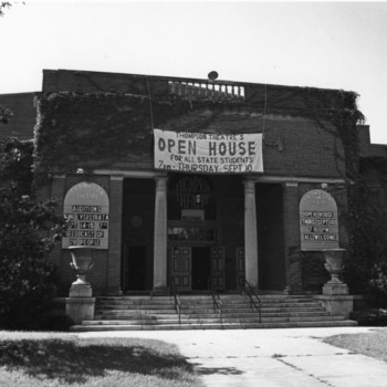 Front view of Thompson Theater, North Carolina State University, showing "Open House" banner hanging above entrance.