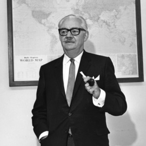 Dean Malcolm E. Campbell in front of map