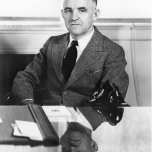 Frank Porter Graham sitting in his office