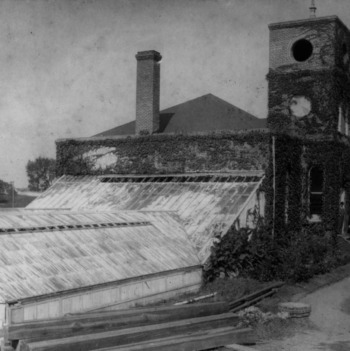 Primrose Hall, built in 1896. The greenhouses were used by horticulture, botany, and arboriculture departments. Tompkins in rear