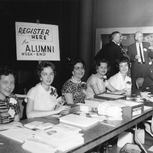 View of five women working at the registration table during Alumni Weekend at North Carolina State College