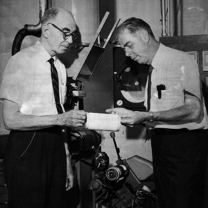 Clarence Asbill and Dr. Robert Work with machinery