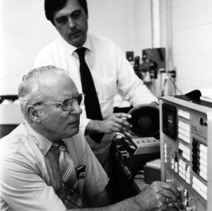 Professor Paul Emerson and Frank D. Hart with machinery