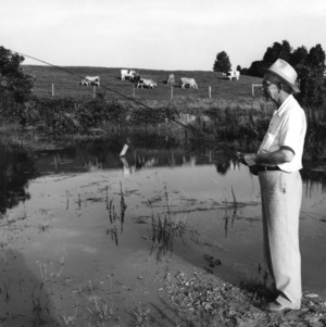 Ira Obed Schaub fishing at pond