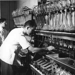 Two men in laboratory checking nitrogen content of tobacco.