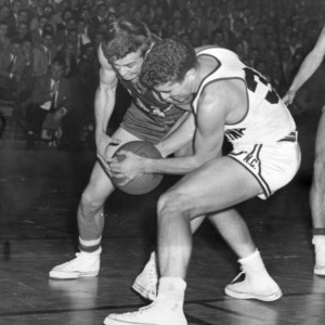 NC State player Mel Thompson and UNC player Gerry McCabe struggle for possession of ball at 1954 game in Chapel Hill