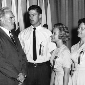 Three of the 1962 North Carolina State 4-H Council officers meeting with an unidentified man