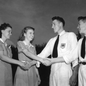 North Carolina State 4-H Council officers shaking hands at the North Carolina State 4-H Short Course in July of 1941
