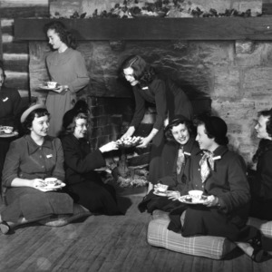 4-H club members having tea in front of a fire