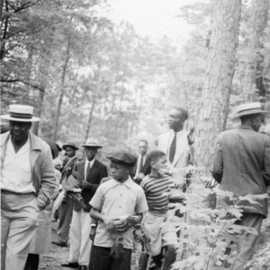 4-H club members searching the woods for leaf samples to identify trees in Wake County, July 14-17, 1941