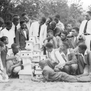Wake County - July 14-17, 1941, Camp Whispering Pines. Club boys inspect bird boxes made by the group to determine the best piece of work