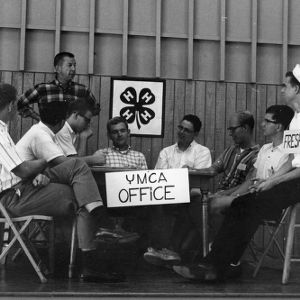 Collegiate 4-H Club sitting at a table labeled "YMCA office"