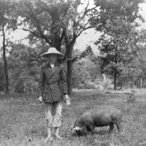Pig club member standing with a pig